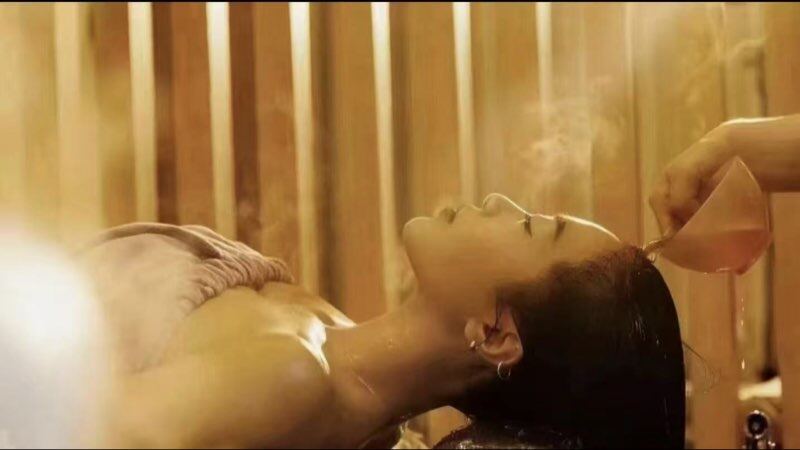 Guest relaxing with aromatic steam during a head spa and face mask treatment