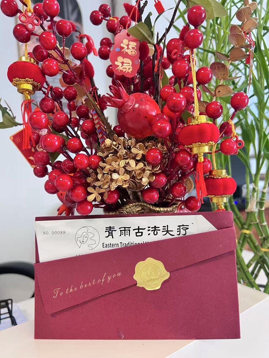 Red and gold gift presentation with flowers at Eastern Head Spa Mineola